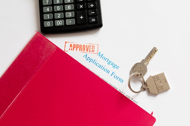 Mortgage papers and house key on a table