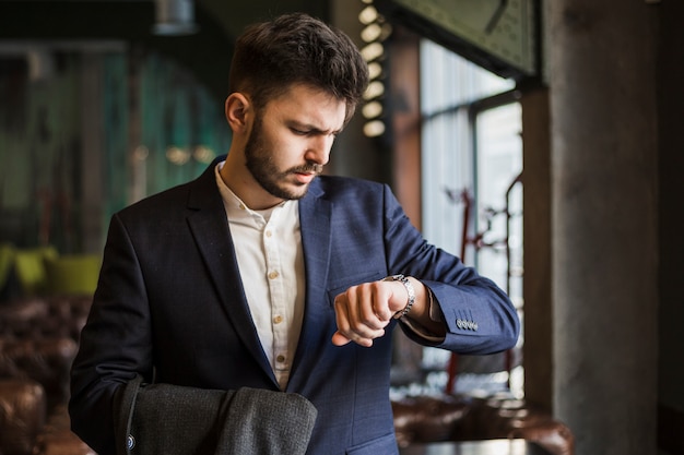 Business professional checking the time during a busy day